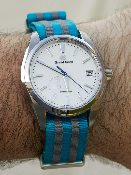 Grand Seiko Snowflake (white dial) worn on a Tropic Bond turquoise and grey striped nylon watch strap